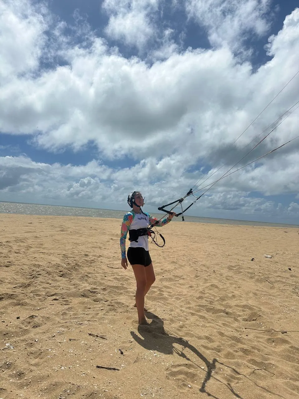 Student on the beach flying the kite