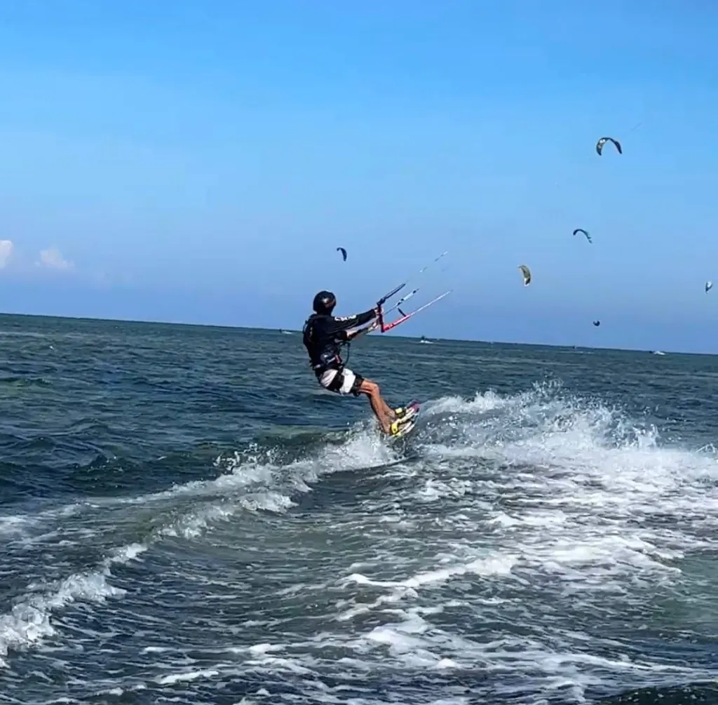 Rider getting up on a kitesurf board